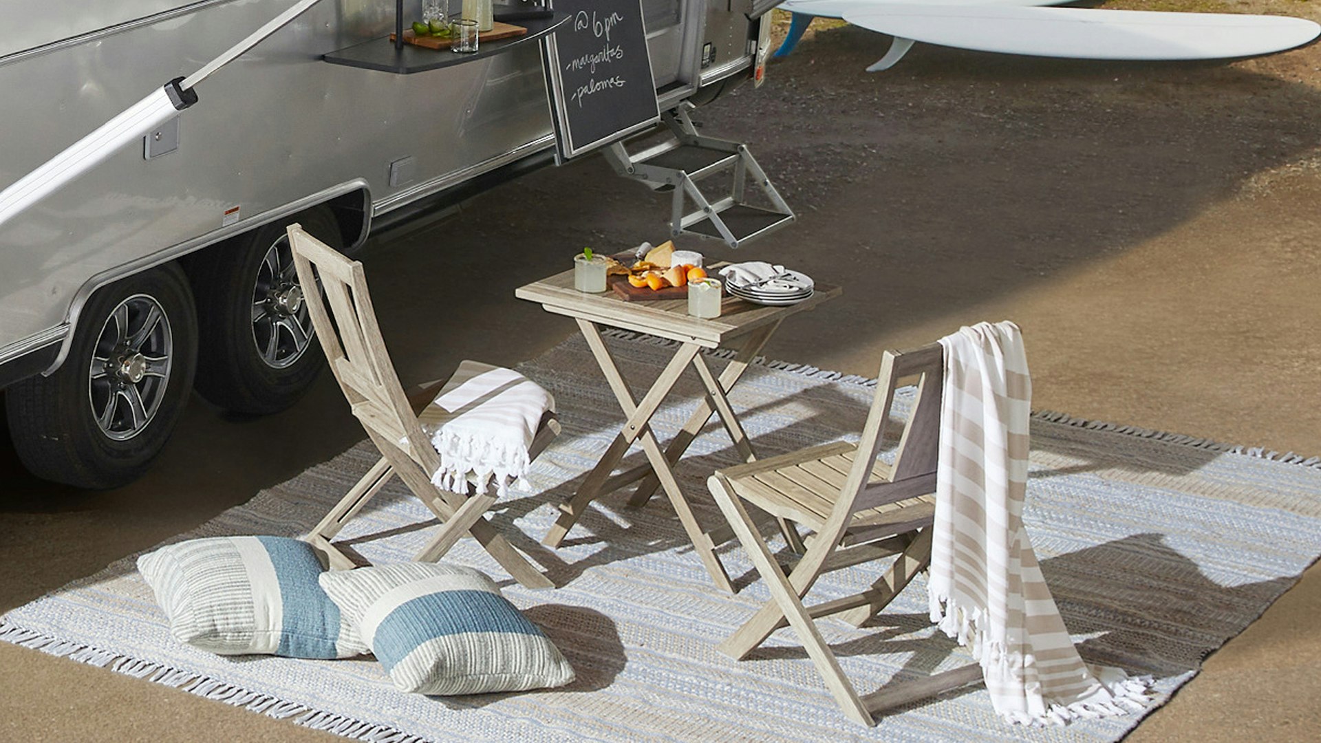 Airstream Pottery Barn Special Edition Travel Trailer exterior image of table and chairs on Pottery Barn rug